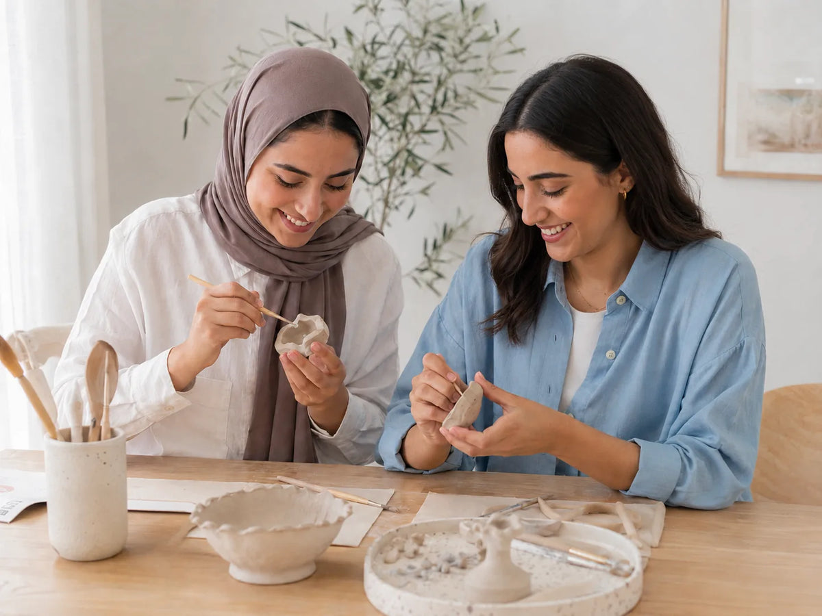 Two women making at-home pottery together